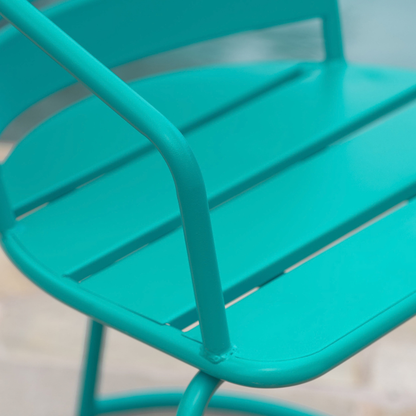 Curved armrest and open seat slats of the teal armchair (close-up detail)