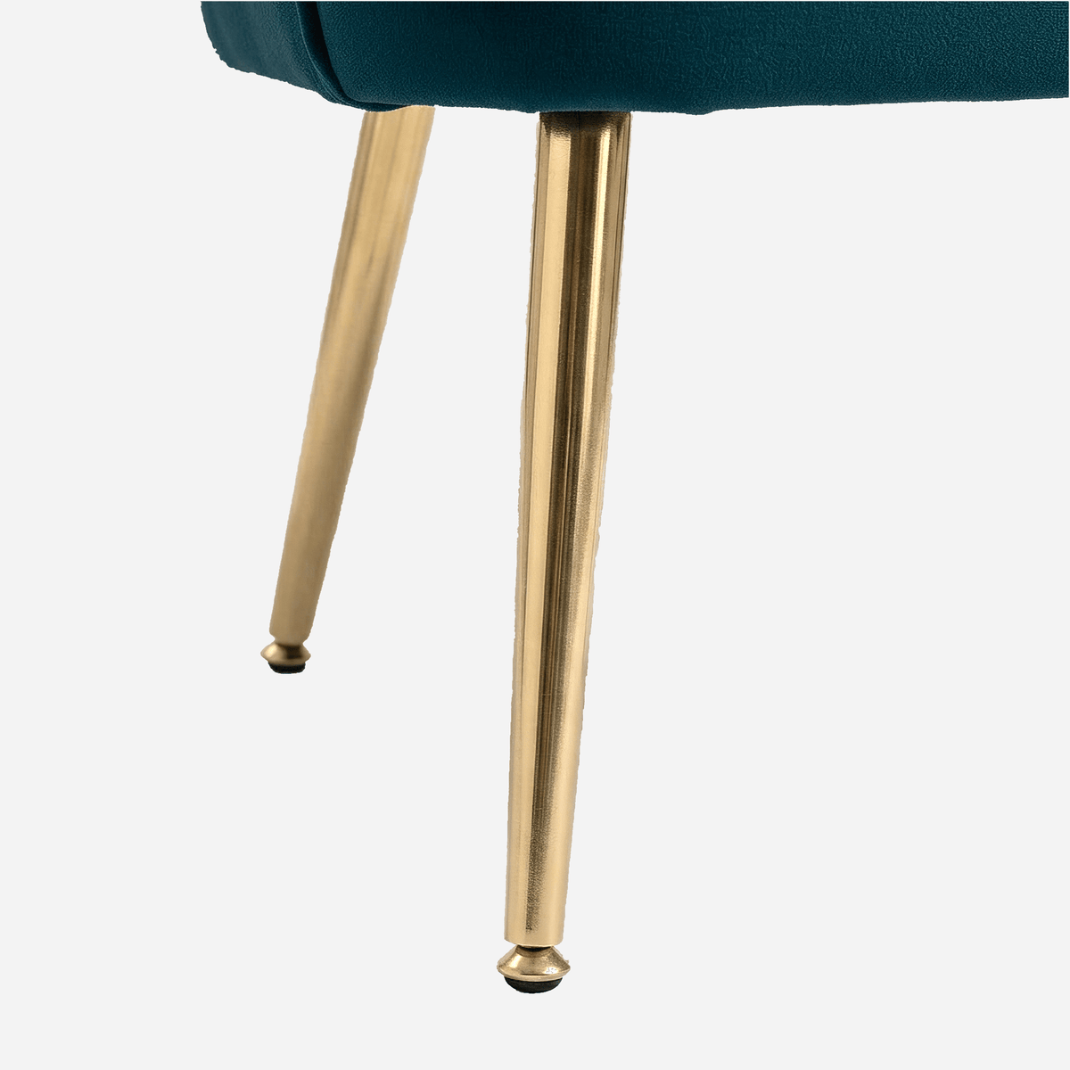 Tapered gold metal leg with a rounded foot cap on the teal velvet chair (close-up detail)