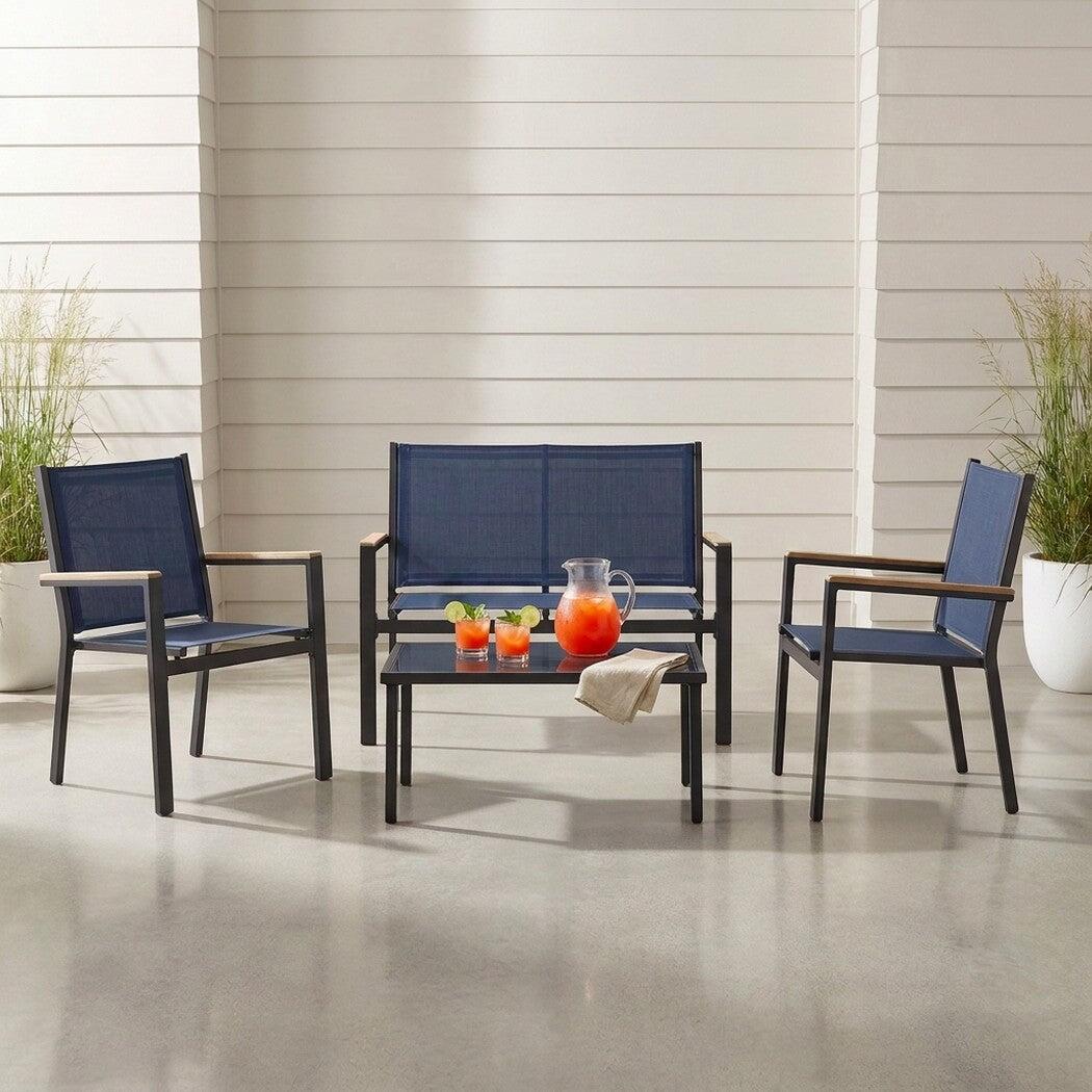 Textilene patio conversation set with glass-top table on a covered patio