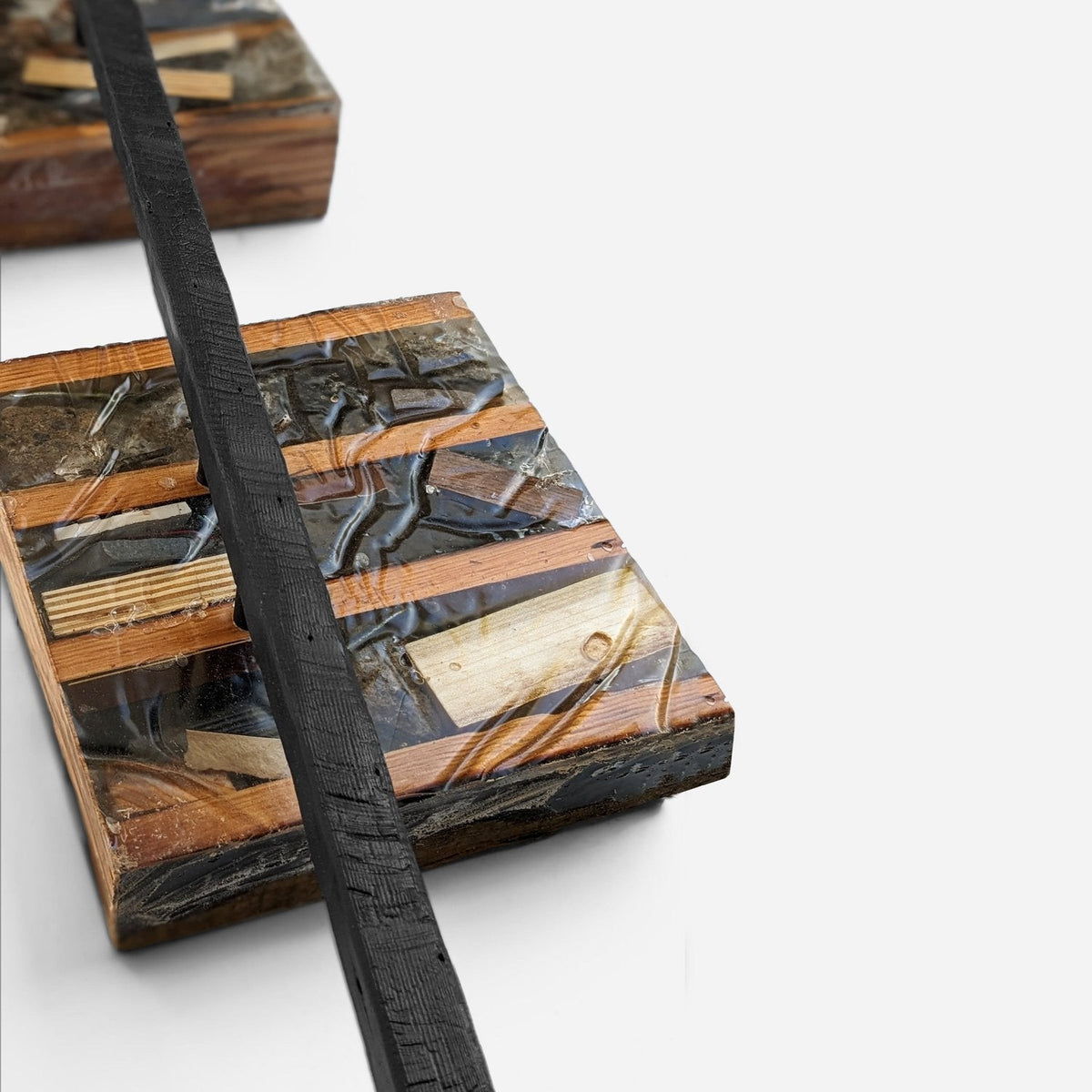 Close-up of the charred black bar crossing a block edge