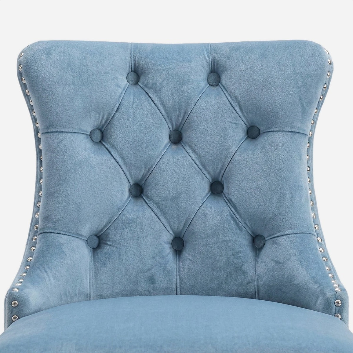 Button-tufted light blue velvet backrest edged in silver studs (close-up detail)