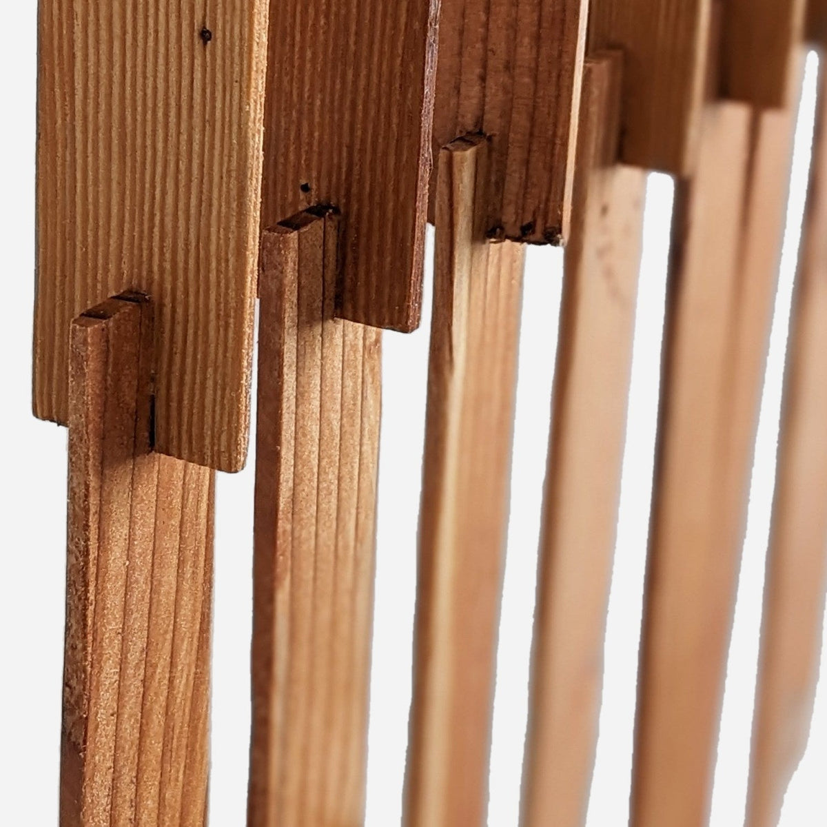 Close-up of intersecting strip joinery and tung oil grain