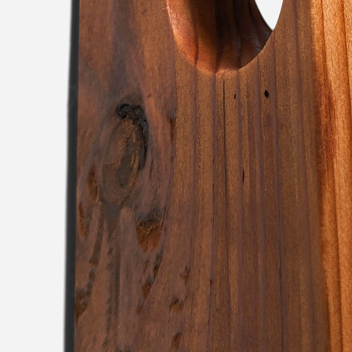 Knot and weathered grain on a reclaimed wood board (close-up detail)