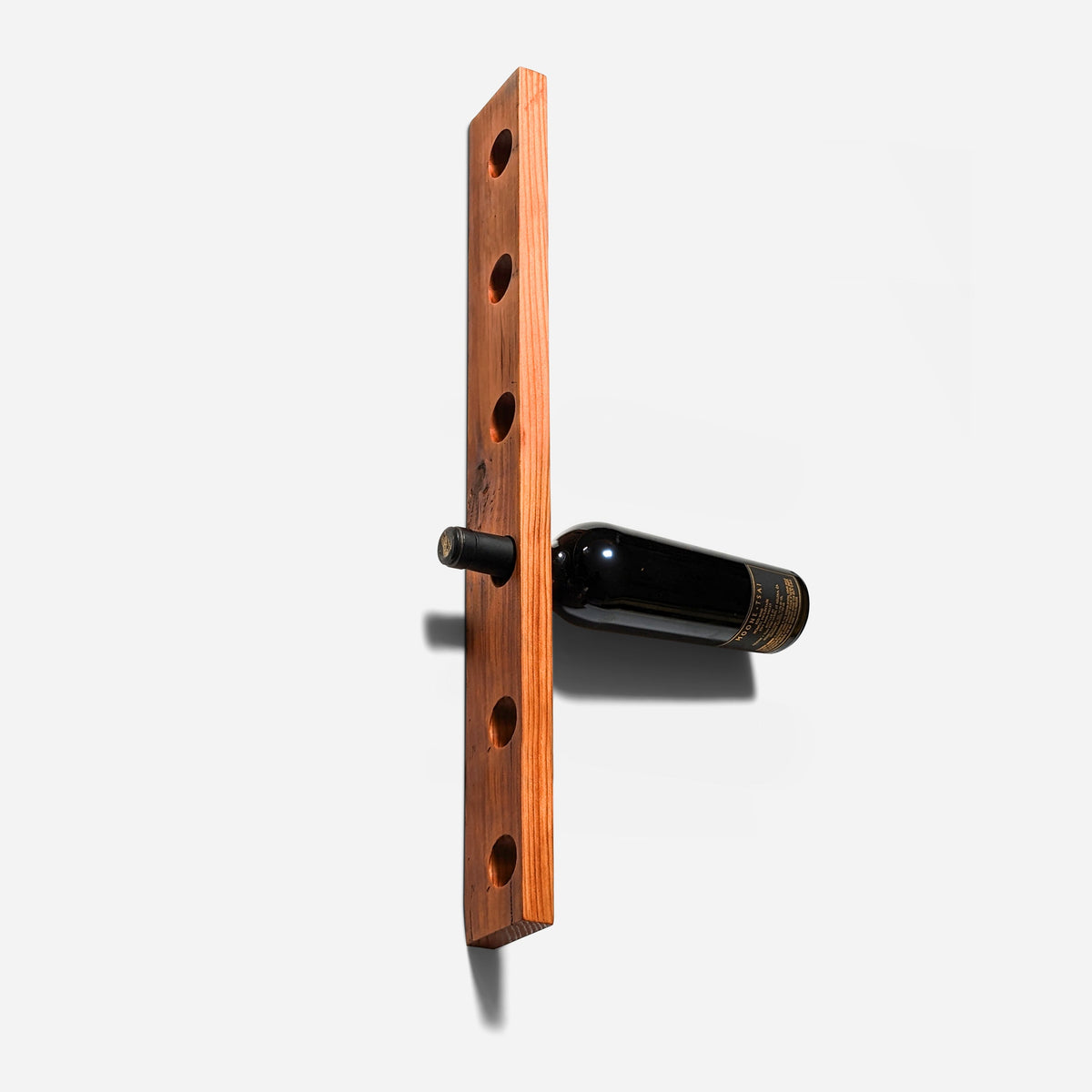 Six-hole reclaimed wood board with one bottle resting in it
