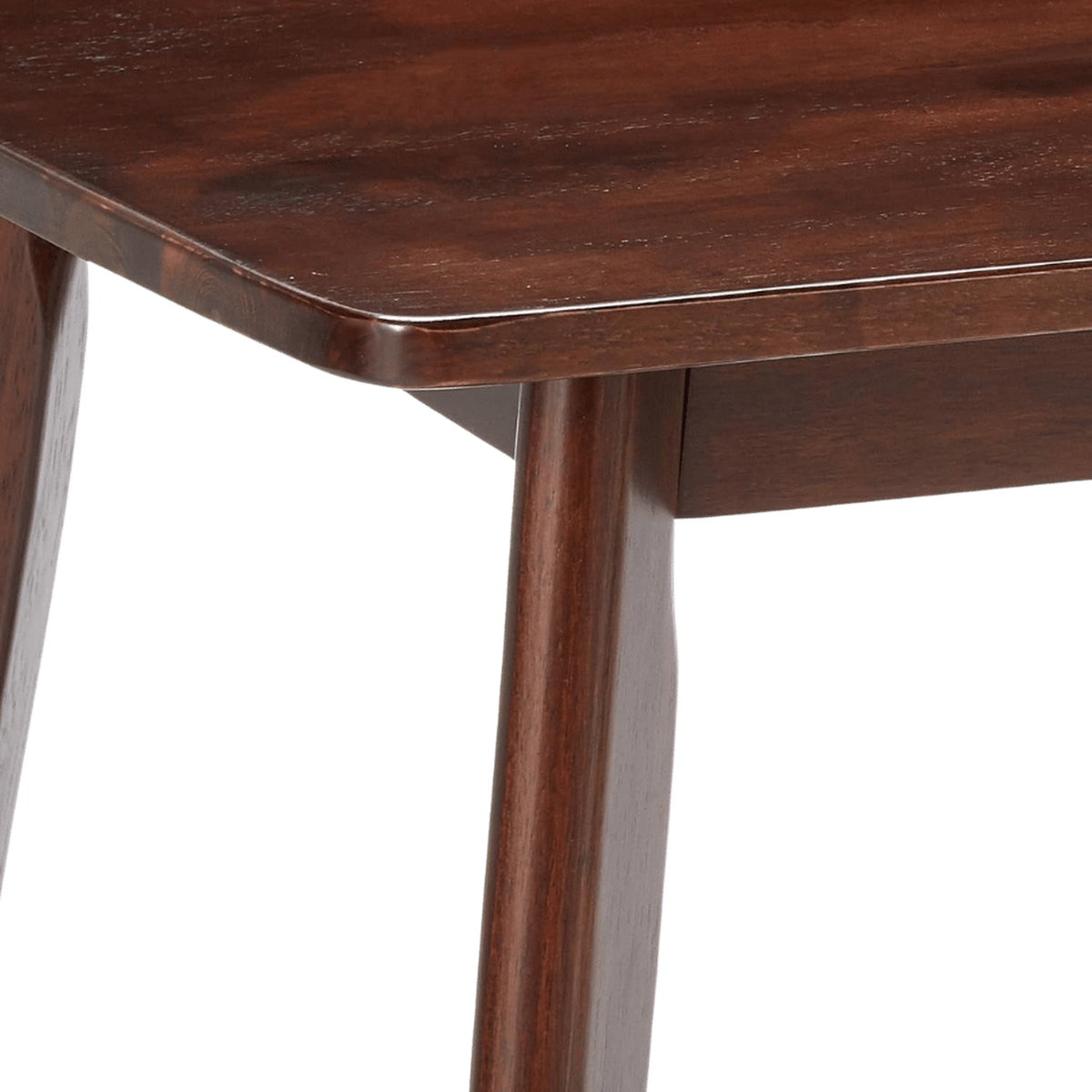 Close-up of the softly rounded top corner over the apron and tapered leg (close-up detail)