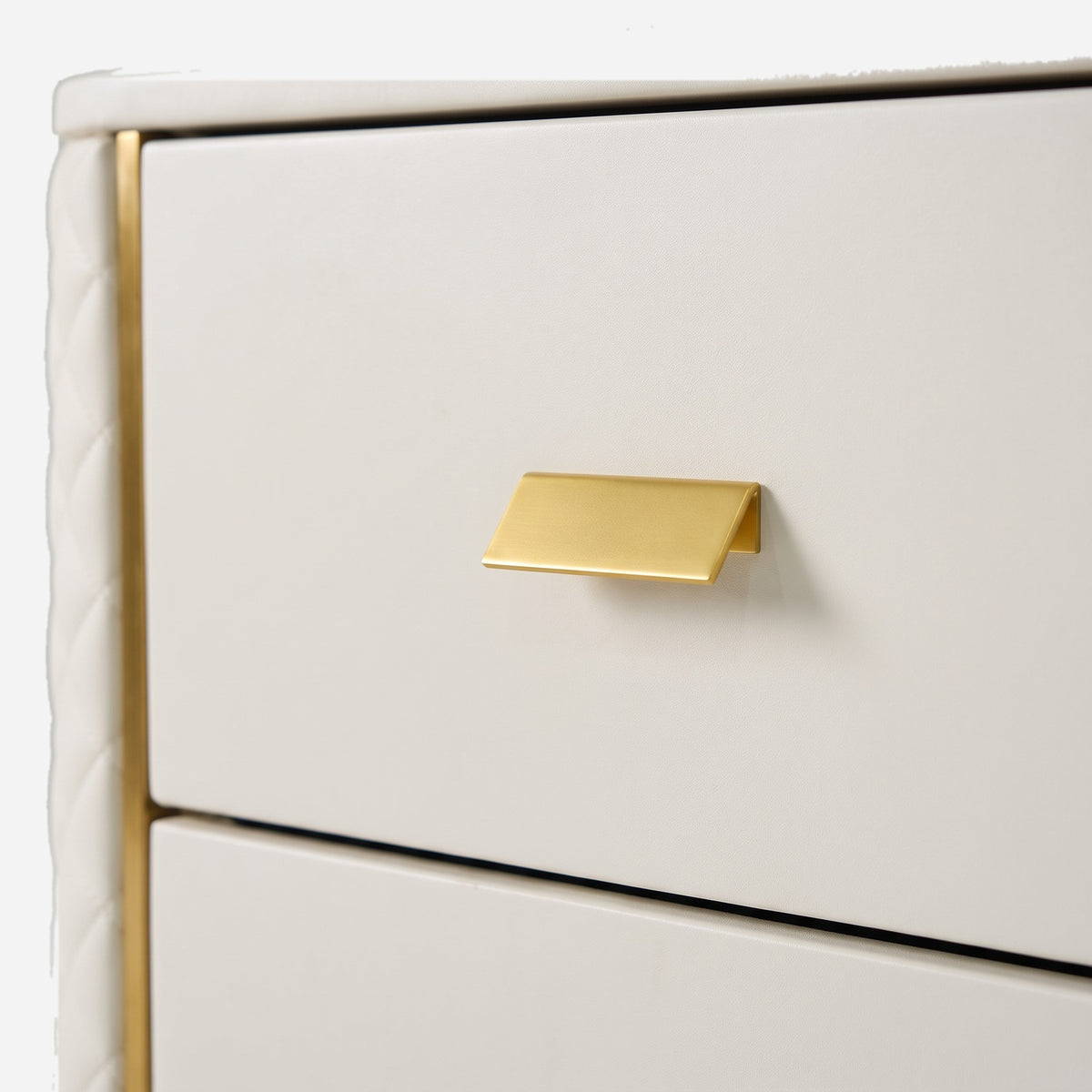 Flat gold bar pull on the smooth ivory drawer front, close up