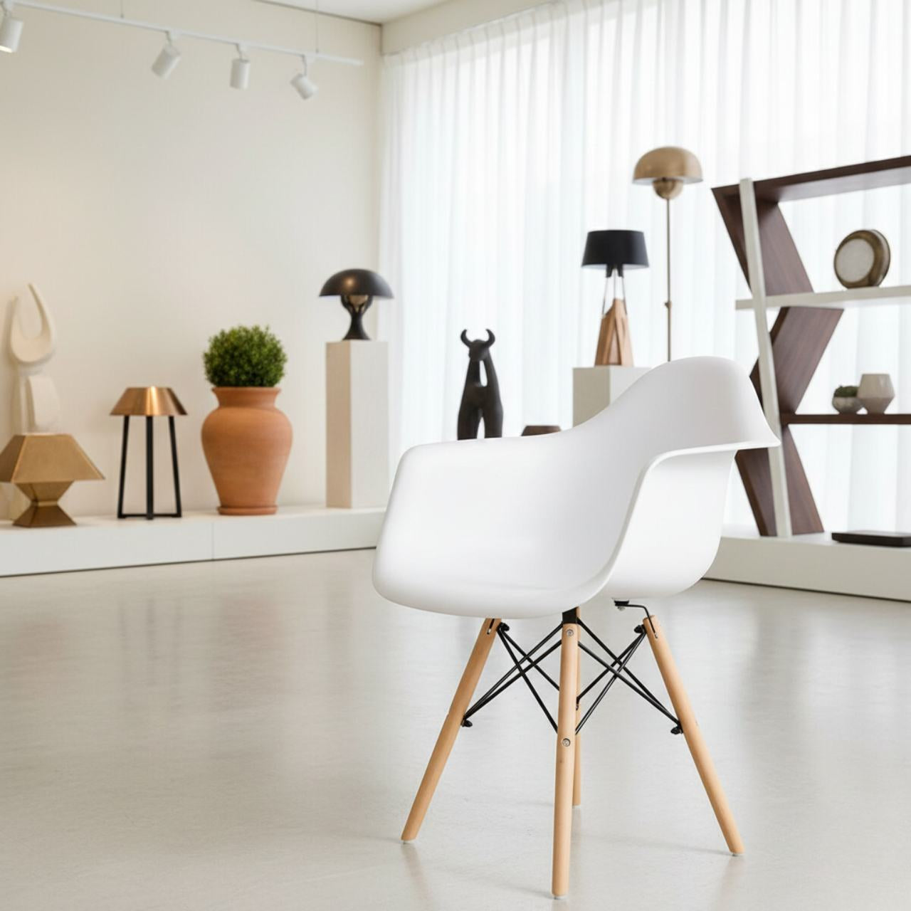 White mid-century modern molded dining arm chair with wooden legs in a minimalist showroom.