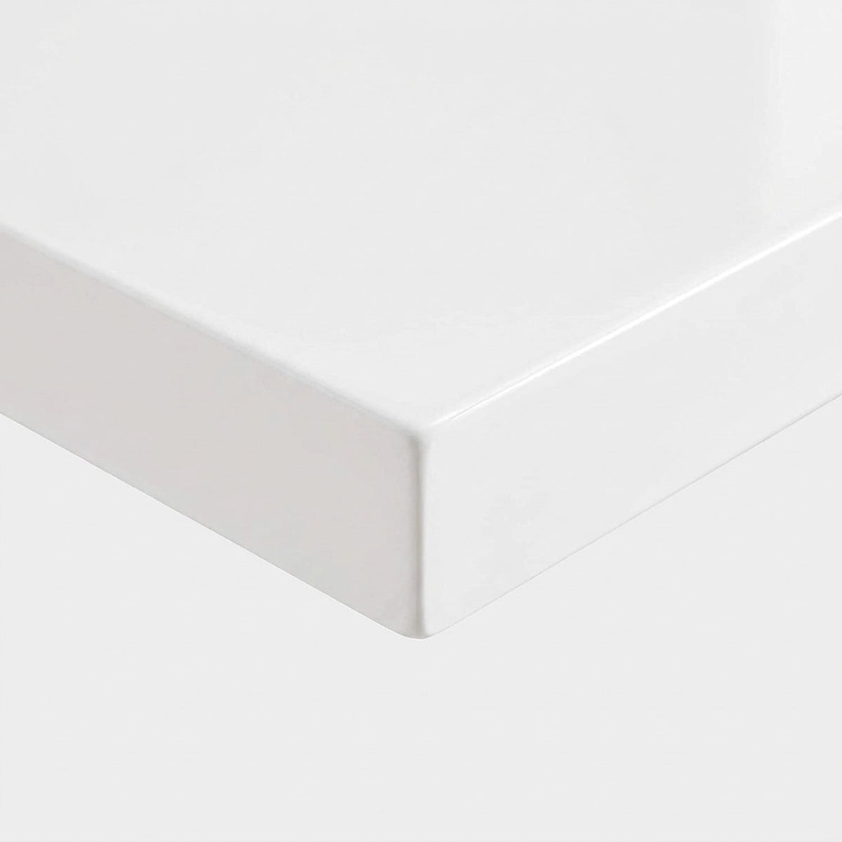 Close-up of the thick high gloss white laminate edge and corner of the dining table top