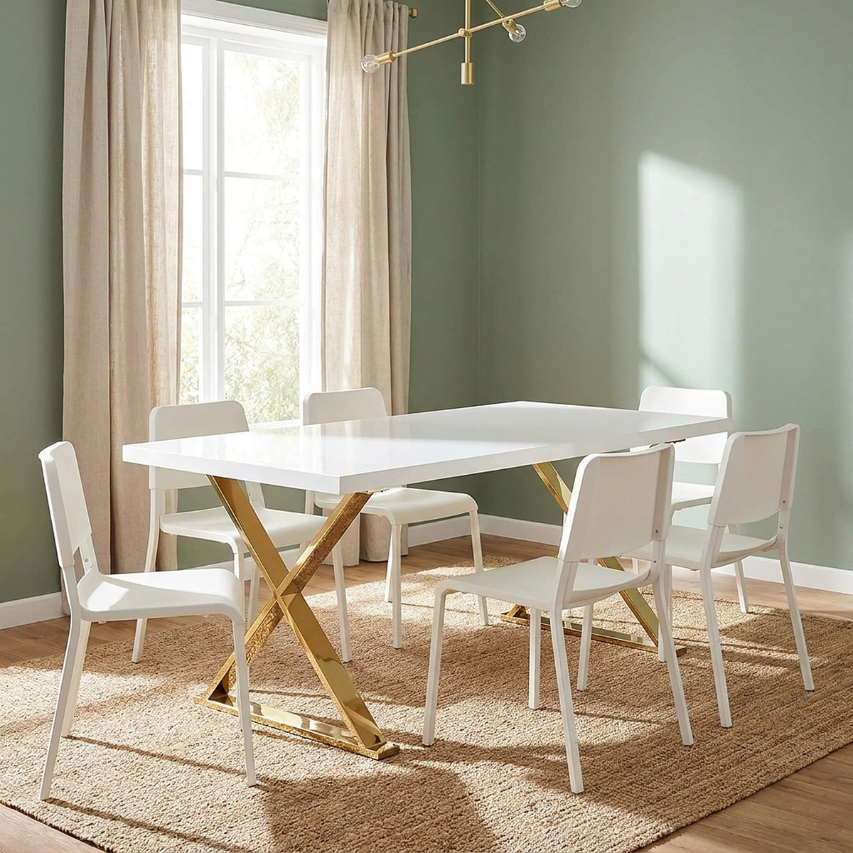 Glossy white table on gold X legs with white chairs in a sage green dining room with linen curtains and a jute rug