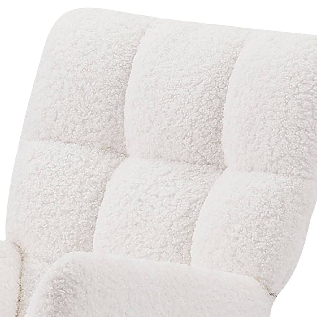 Cream textured boucle upholstery close-up on a stylish rocking chair for the living room.