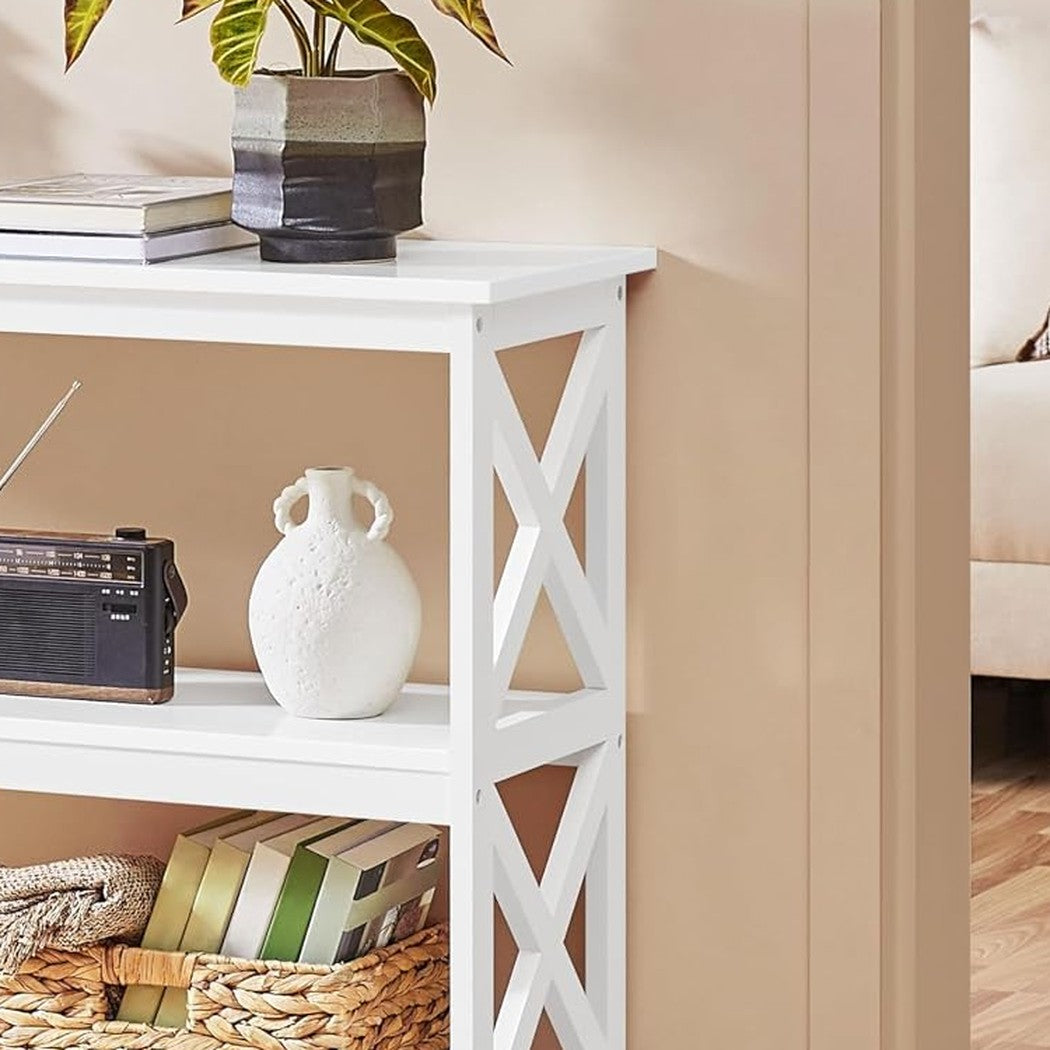 Close-up of the upper X-brace with books and a planter on the console shelf in a styled hallway