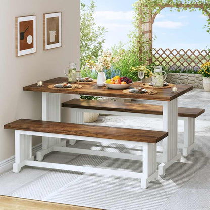 47-inch white farmhouse dining table with two benches and brown wood top, set for four in a garden view dining area.