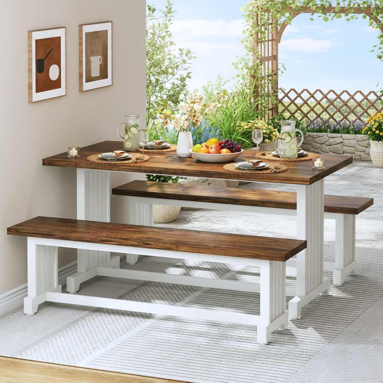 47-inch white farmhouse dining table with two benches and brown wood top, set for four in a garden view dining area.