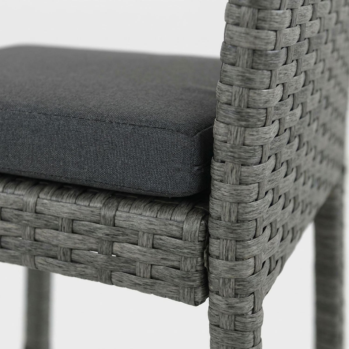 Dark gray cushion on the woven stool seat (close-up detail)