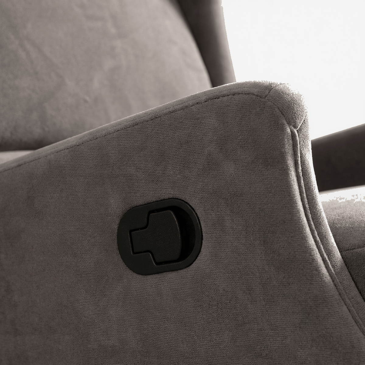 Black recline handle set into the arm of the dark gray chair (close-up detail)