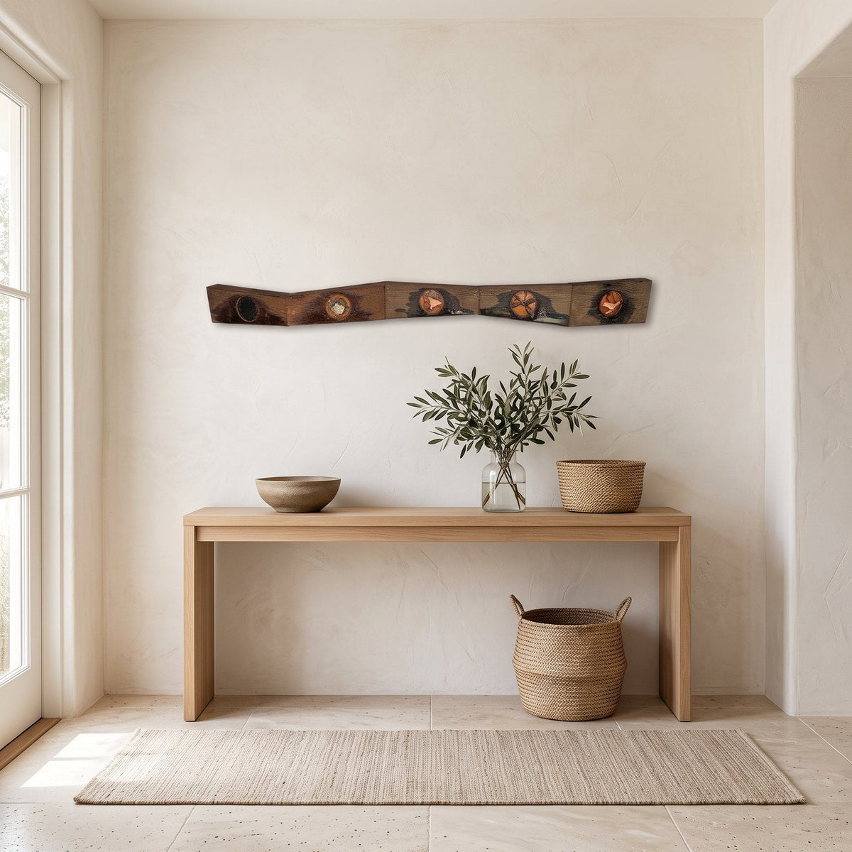 Zig zag wood and resin strip hung above a light oak console in a bright foyer