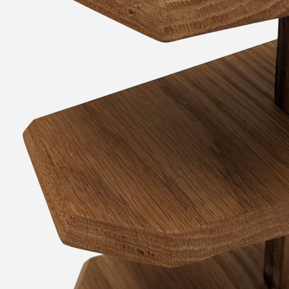 Flat fir serving tier fixed to the darker centre post (close-up detail)
