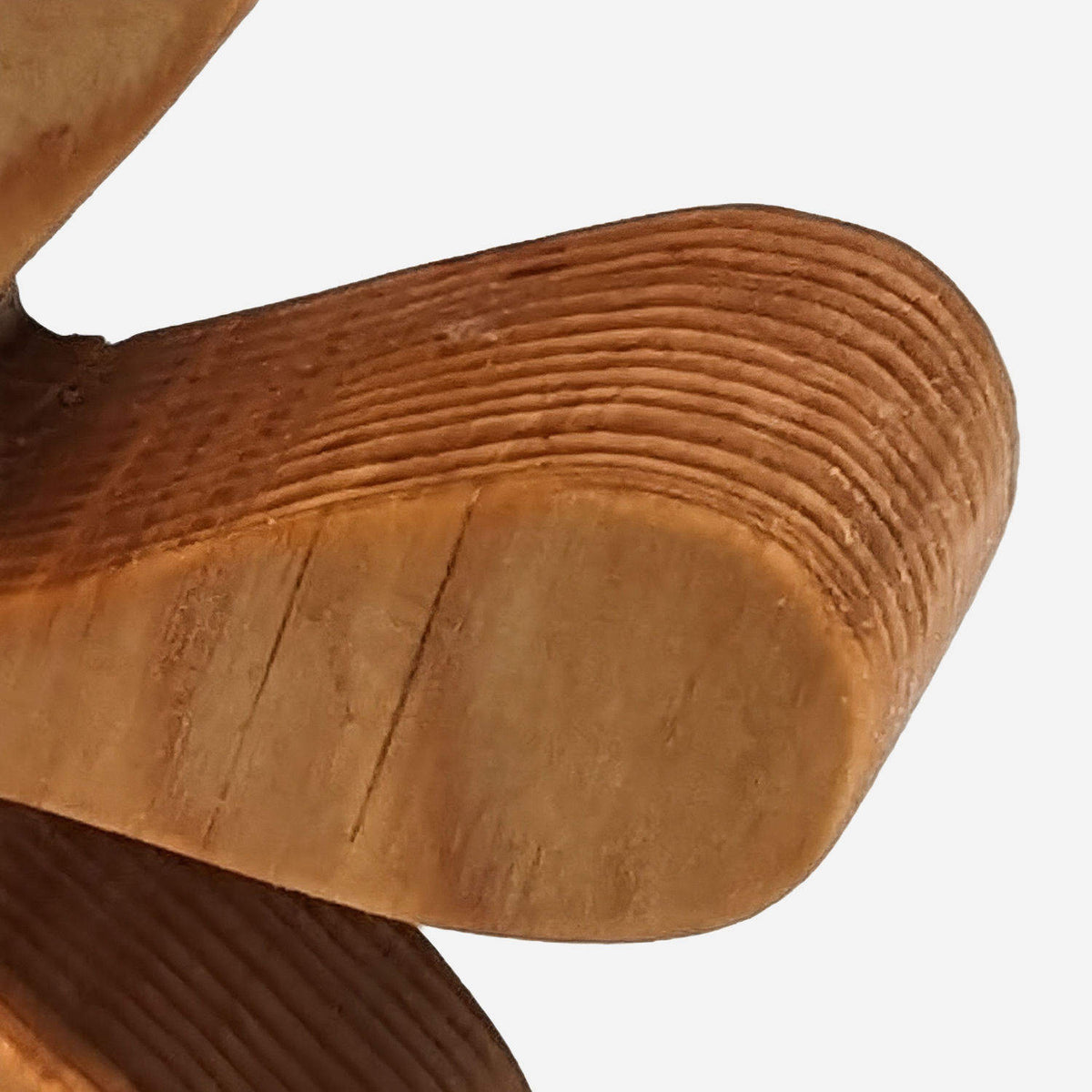 Layered growth-ring grain on the arm ends of wooden starburst bookends