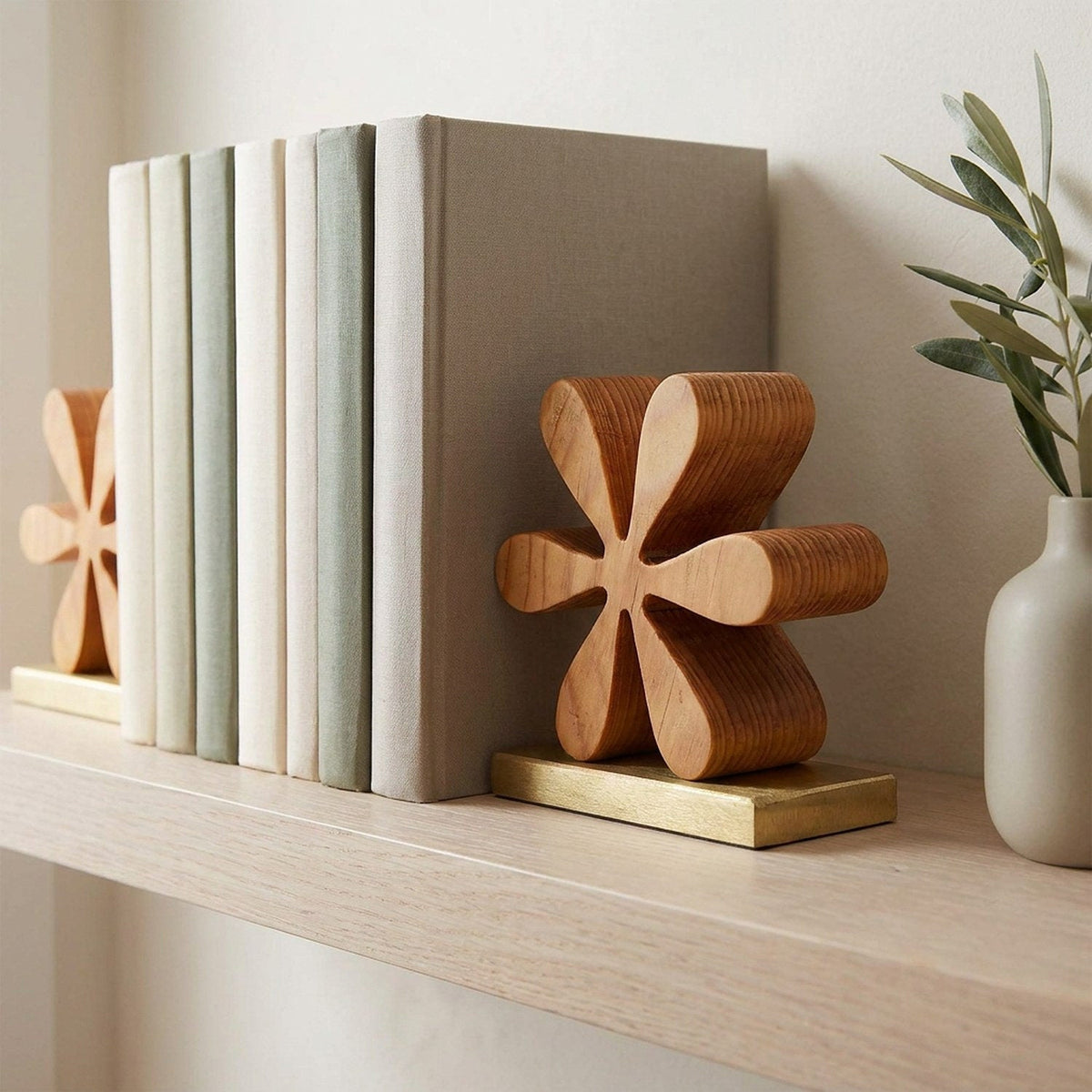 Close view of a wooden starburst bookend holding cloth-bound books