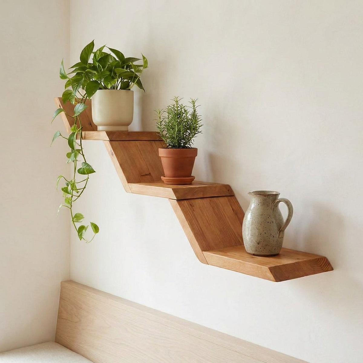 Closer view of stepped reclaimed wood shelves in a breakfast nook with trailing plants and a stoneware jug